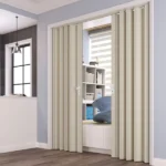 Beige accordion door partially open to bright room