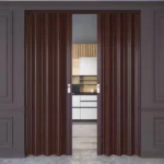Brown PVC accordion doors partially open to a kitchen