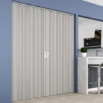 Closed grey double folding door in blue room interior