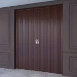 Closed mahogany folding doors in a paneled wall room.