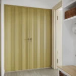 Fully closed olive green accordion door in hallway.