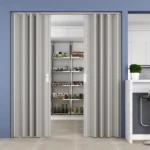 Grey PVC folding pantry door open to kitchen shelves