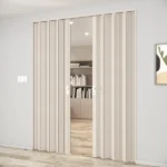 Modern white folding doors opening into a library room.