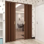 Teak accordion door partially open to dining area